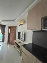 1 Bedroom Condo for Rent at Laguna Beach Resort 2 kitchen with black countertop stove and wall-mounted TV view