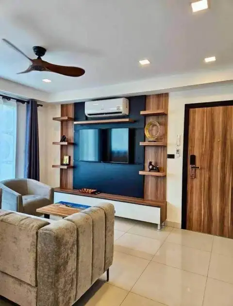 2 Bedroom Condo for Rent at Laguna Beach Resort 2 living room with wood-paneled TV wall and armchair seating