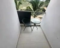 1 Bedroom Condo for Rent at Laguna Beach Resort 3 (The Maldives) private balcony with table, chair and palm tree view
