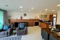 2 Bedroom Condo for Sale & Rent at Laguna Heights open-plan living area with wooden cabinetry and kitchen pass-through