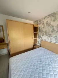 2 Bedroom Condo for Rent at Lanna Condo bedroom with sliding wardrobe closet and floral patterned wallpaper