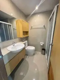 2 Bedroom Condo for Rent at Lanna Condo bathroom with sink vanity, toilet and glass shower enclosure