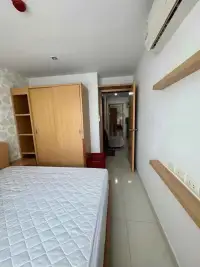 2 Bedroom Condo for Rent at Lanna Condo bedroom with wardrobe, wall shelves, air conditioning unit and hallway view