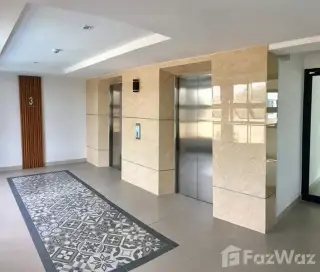 Lanna Condo bathroom with vanity sink, toilet, and glass shower stall in Pattaya
