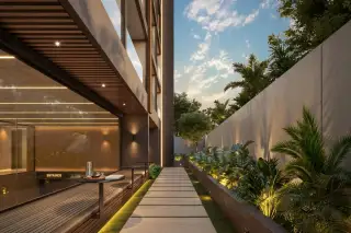 Level Pratumnak outdoor swimming pool with waterfall feature, in-pool sun loungers and lush tropical landscaping