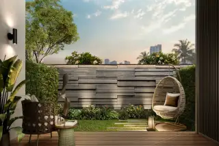 Level Pratumnak condo building exterior aerial view showing gold facade, rooftop garden and beachside palm tree surroundings