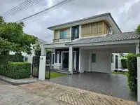 4 Bedroom House for Rent at Life in the Garden Rongpo - Motorway two-story home exterior with covered carport and gated entrance