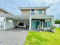 4 Bedroom House for Rent at Life in the Garden Rongpo - Motorway two-story exterior with carport and front lawn