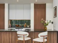 3 Bedroom House for Sale at Sunplay Bangsaray kitchen counter with bar stools and wooden cabinetry