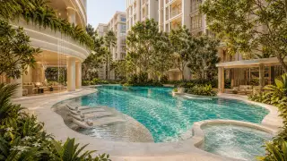 Love It Wongamat Beach resort-style pool with dramatic waterfall feature curved balconies and tropical gardens