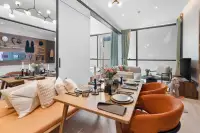 1 Bedroom Condo for Sale at Once Wong Amat dining table with place settings and living room with floor-to-ceiling windows
