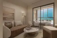 2 Bedroom Condo for Sale at Lucean Bay Jomtien Pattaya living area with sofa and glass-partitioned bedroom overlooking sea view