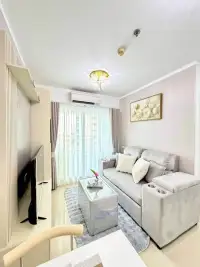 1 Bedroom Condo for Sale at Lumpini Park Beach Jomtien bright living room with gray sofa and crystal ceiling light