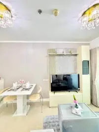 1 Bedroom Condo for Sale at Lumpini Park Beach Jomtien dining table with TV console and crystal wall sconces