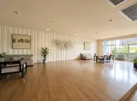 1 Bedroom Condo for Rent at Lumpini Park Beach Jomtien spacious common lounge with wooden floor and seating