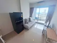 1 Bedroom Condo for Sale at Lumpini Park Beach Jomtien living area with black refrigerator and city view balcony