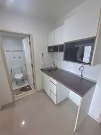 1 Bedroom Condo for Sale at Lumpini Park Beach Jomtien kitchenette with microwave and adjoining bathroom