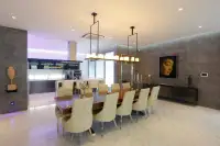 8 Bedroom House for Sale in Pratumnak Hill elegant dining area with long wooden table and Buddha wall art