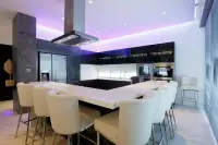 8 Bedroom House for Sale in Pratumnak Hill modern kitchen with white island counter and purple ambient lighting