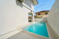 4 Bedroom House for Sale at Wonderland II private plunge pool between white walls with outdoor lounge seating