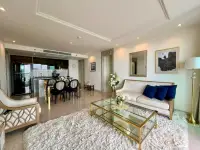 2 Bedroom Condo for Sale at Riviera Monaco living room with plush rug, sofa, and kitchen view