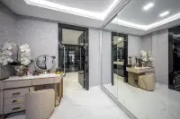 2 Bedroom Condo for Sale at Grand Solaire Noble dressing area with vanity table gold accents and floor-to-ceiling mirrored wardrobe