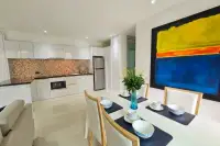 5 Bedroom House for Rent at Casa Jomtien open-plan dining area and white kitchen with mosaic backsplash