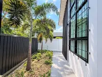3 Bedroom House for Sale in Mabprachan side garden walkway with palm trees and pebble landscaping