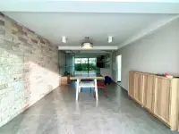 4 Bedroom House for Sale in Mabprachan dining area with stone accent wall and outdoor garden view