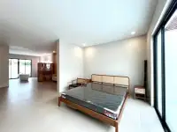 4 Bedroom House for Sale in Mabprachan bedroom with wooden bed frame and open view to bathtub area