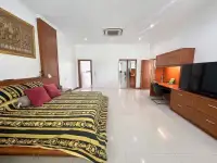 5 Bedroom House for Sale & Rent in Mabprachan master bedroom with patterned bedspread and built-in wood cabinetry