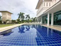 5 Bedroom House for Sale & Rent in Mabprachan long tiled swimming pool beside home with palm tree reflections