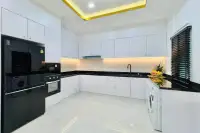 5 Bedroom House for Sale in Mabprachan modern kitchen with black countertops, white cabinetry, and built-in appliances