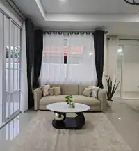 3 Bedroom House for Sale in Mabprachan living room with beige sofa, marble coffee table and sheer curtains
