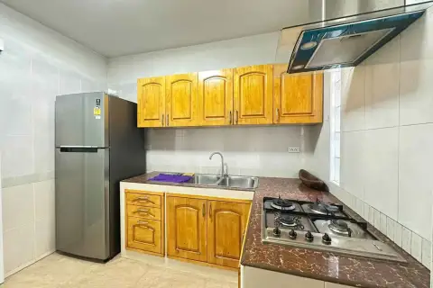 3 Bedroom House for Rent in Mabprachan kitchen with wooden cabinets, gas stove and stainless steel refrigerator