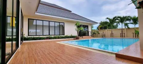 3 Bedroom House for Rent at Horseshoe Point poolside view with palm trees and wooden deck patio