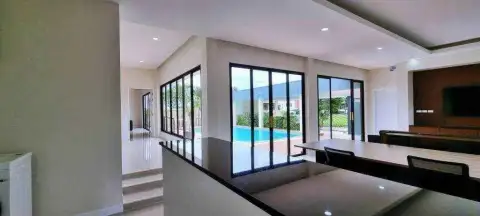 3 Bedroom House for Rent at Horseshoe Point open-plan kitchen counter with pool view through glass doors