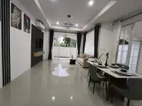 3 Bedroom House for Sale in Mabprachan spacious lounge with dining table, TV wall and garden view