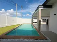 3 Bedroom House for Sale in Mabprachan side view of pool with wooden deck and covered carport