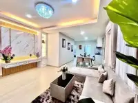 3 Bedroom House for Sale in Mabprachan open-plan living room with gray sofa and dining area view