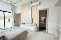 4 Bedroom House for Sale in Mabprachan master bedroom with king bed, wall-mounted TV and ensuite bathroom