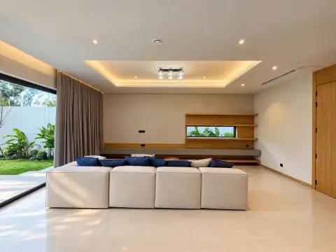 4 Bedroom House for Rent in Mabprachan spacious lounge with sectional sofa and garden view
