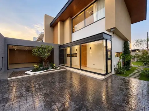 4 Bedroom House for Rent in Mabprachan exterior view of two-story house with stone driveway