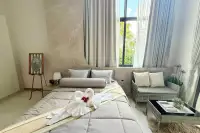 4 Bedroom House for Sale in Mabprachan cozy bedroom with large window, seating area and decorative towel swans