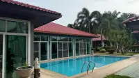 4 Bedroom House for Rent in Mabprachan pool deck with stone statues and tropical landscaping