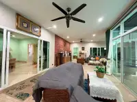 4 Bedroom House for Rent in Mabprachan open-plan living room with brick accent wall and ceiling fan