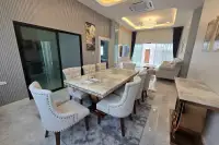 4 Bedroom House for Rent in Mabprachan with marble dining table, upholstered chairs, and open living space