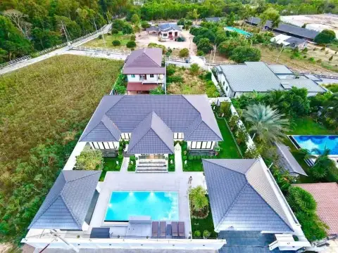 5 Bedroom House for Sale in Mabprachan aerial view showing tiled roofs, pool, and surrounding greenery