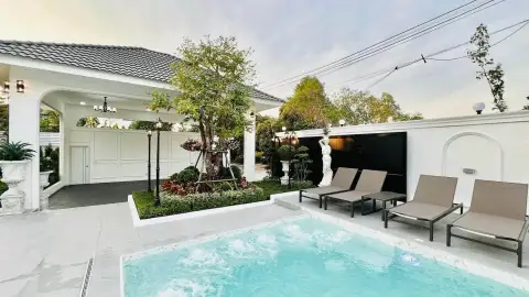 5 Bedroom House for Sale in Mabprachan jacuzzi pool with lounge chairs and garden statue near carport