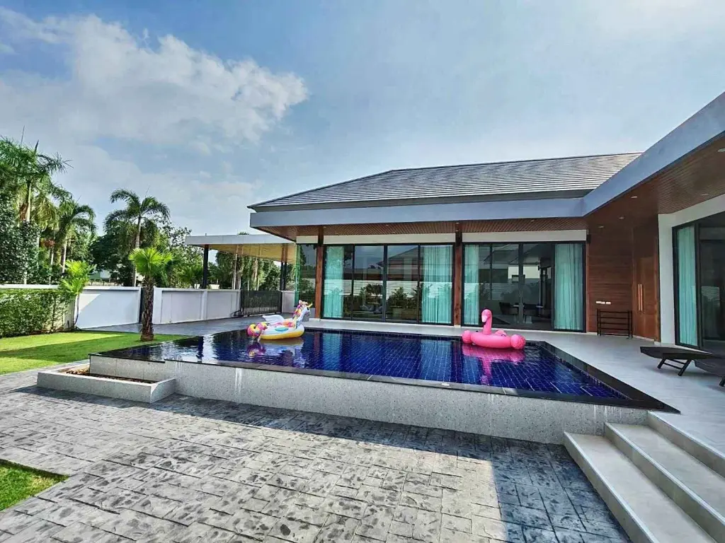 5 Bedroom House for Rent in Mabprachan modern pool villa exterior with pool floats and tropical garden